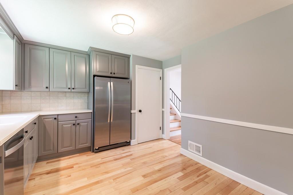 175 Powers Road Sudbury, MA 01776 - Photo 15 of 32 a kitchen with granite countertop a refrigerator and cabinets