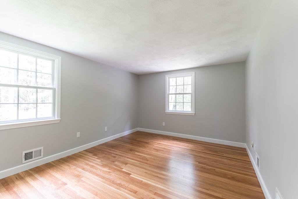 175 Powers Road Sudbury, MA 01776 - Photo 20 of 32 an empty room with wooden floor and windows