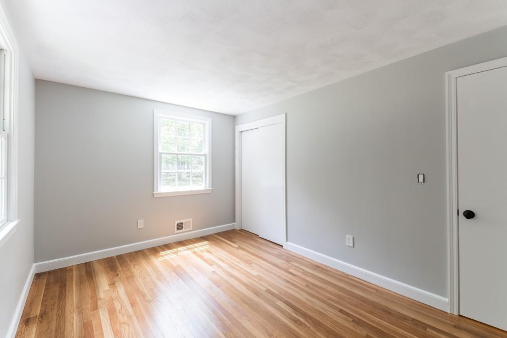 175 Powers Road Sudbury, MA 01776 - Photo 24 of 32 a view of empty room with wooden floor and fan