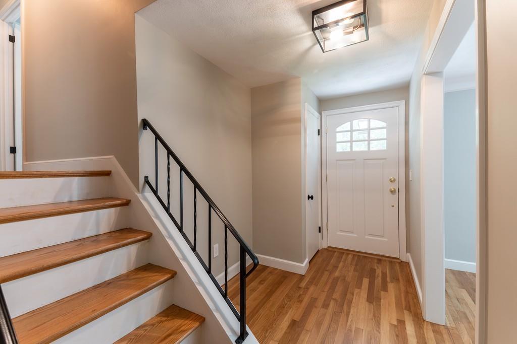 175 Powers Road Sudbury, MA 01776 - Photo 4 of 32 a view of entryway and hall with wooden floor