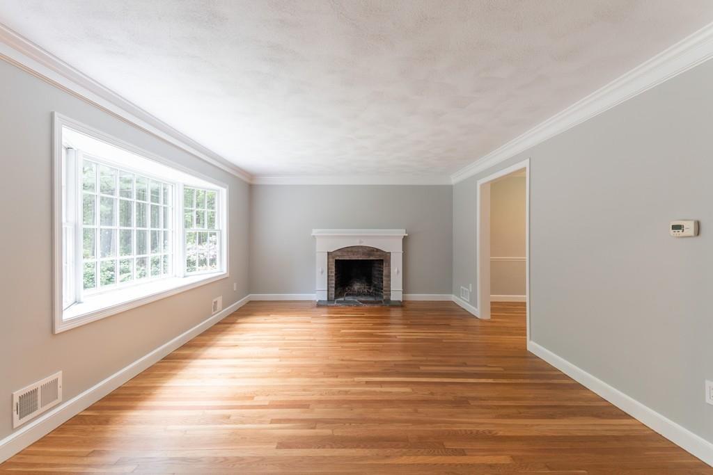 175 Powers Road Sudbury, MA 01776 - Photo 5 of 32 a view of an empty room with a window and fireplace