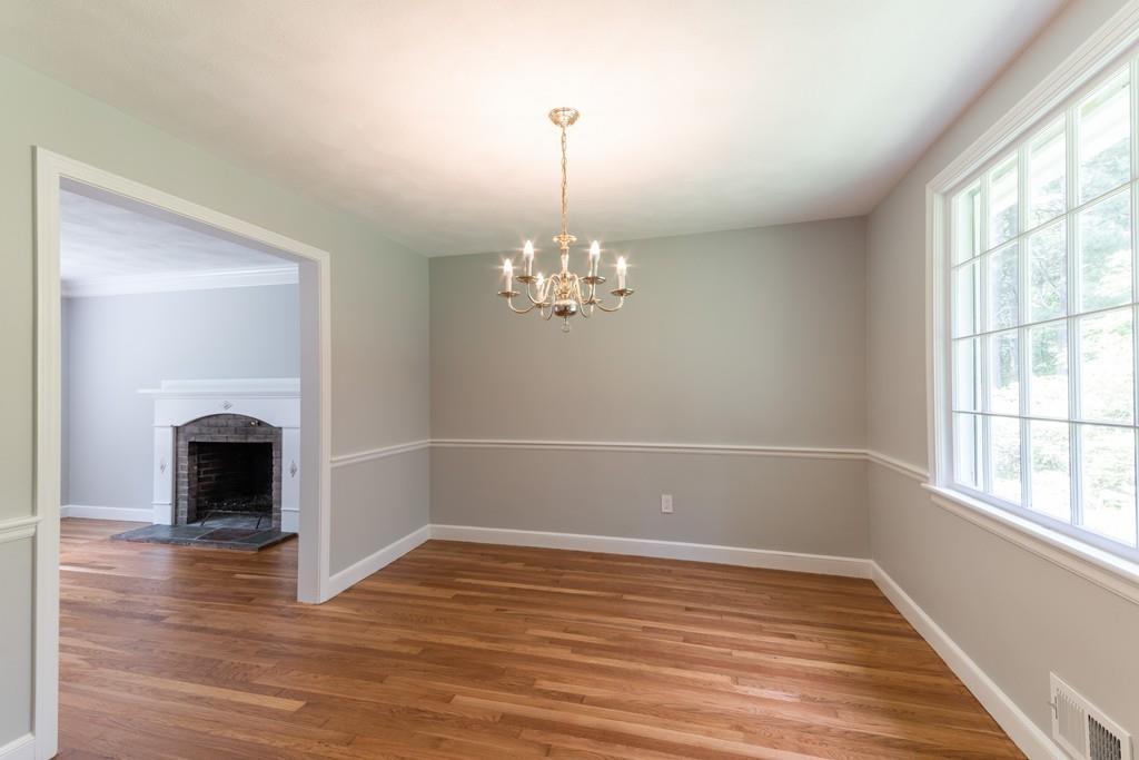 175 Powers Road Sudbury, MA 01776 - Photo 9 of 32 a view of an empty room with wooden floor and a window