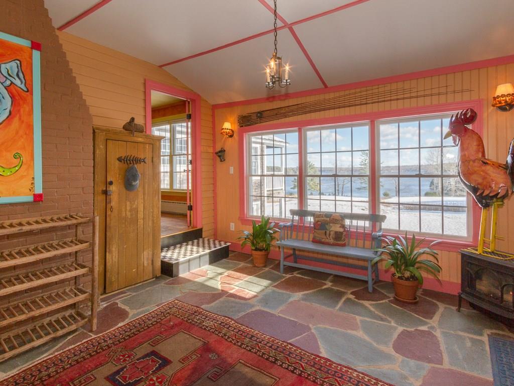 120 Phipps Point Road Woolwich, ME 04579 - Photo 6 of 35 A gas stove keeps this room warm and...