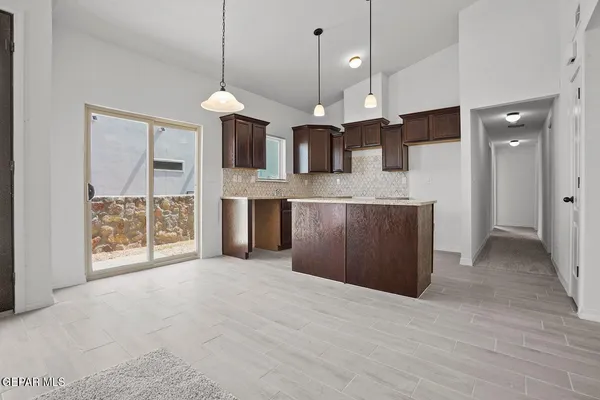 a view of a kitchen with a sink and a chandelier