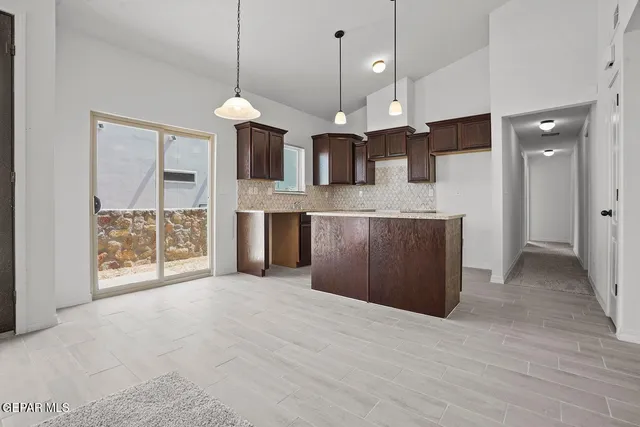 a view of a kitchen with a sink and a chandelier