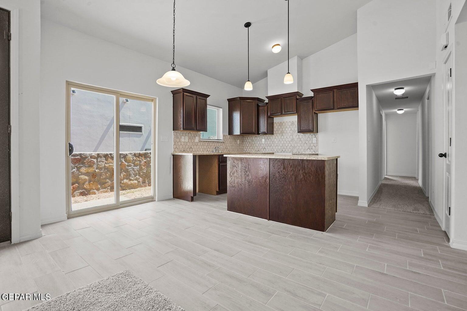 257 Farnborough Street El Paso, TX 79928 - Photo 11 of 34 a view of a kitchen with a sink and a chandelier