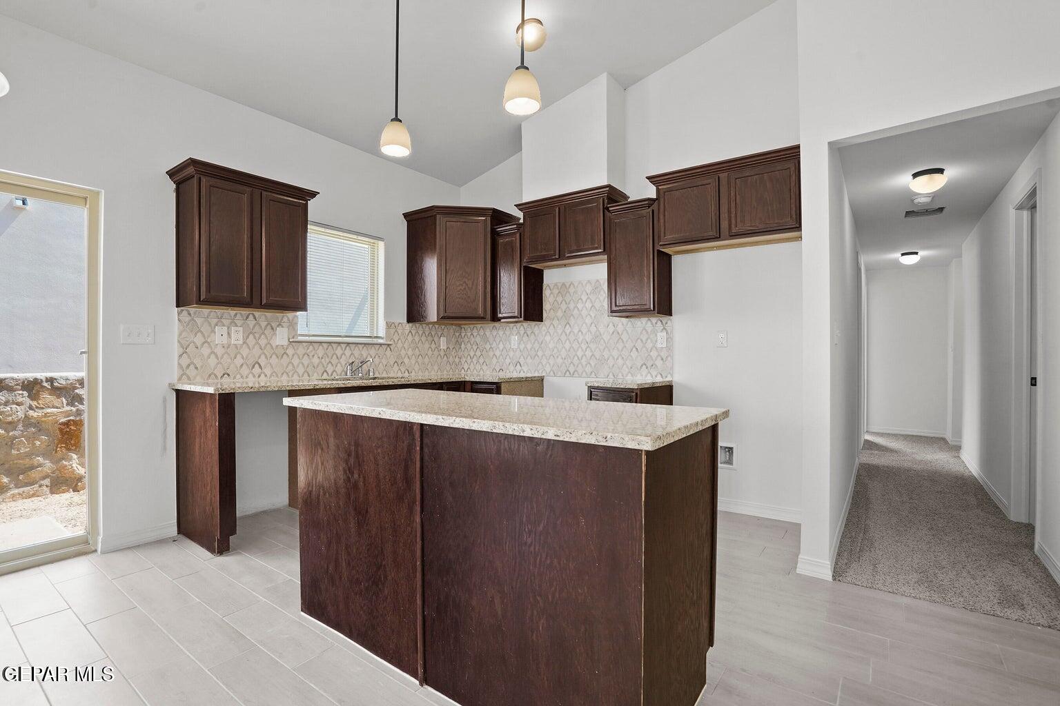 257 Farnborough Street El Paso, TX 79928 - Photo 12 of 34 a kitchen with stainless steel appliances granite countertop a sink a stove and a refrigerator