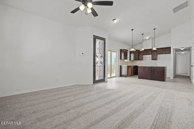 a view of a kitchen with furniture and a ceiling fan