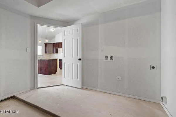 a view of a room with wooden floor and cabinet