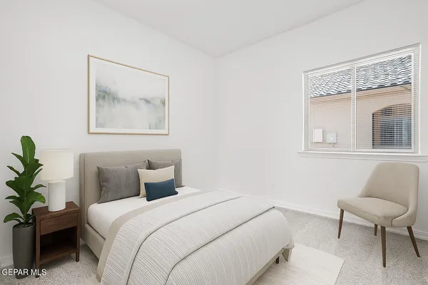 a bedroom with a bed and a painting on the wall