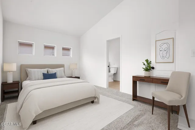 a bedroom with a bed and a couch