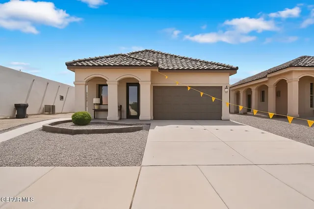 a view of a house with potted plants