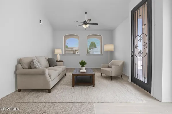 a living room with furniture and a chandelier