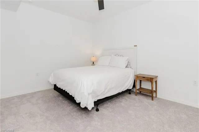 a bedroom with a bed and a stool