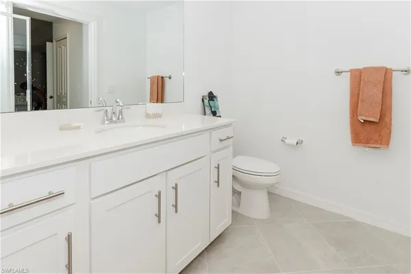 a bathroom with a sink toilet and a mirror