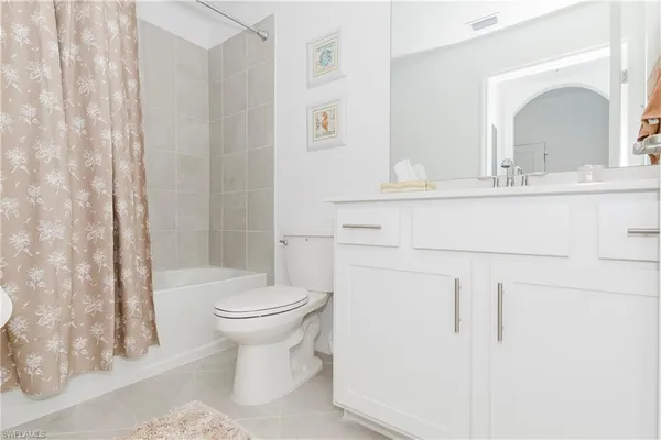 a bathroom with a toilet sink and a mirror