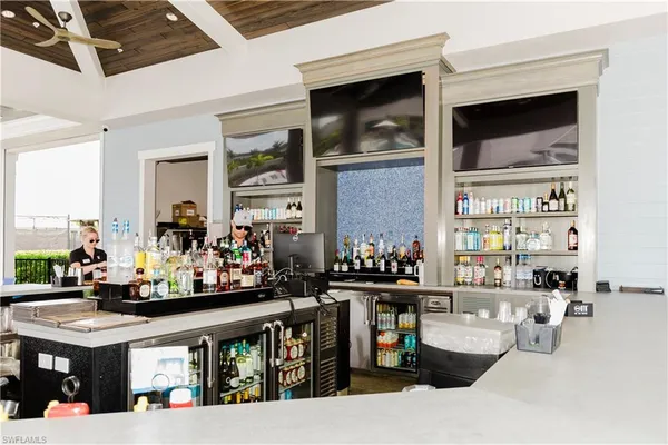 a dining hall with stainless steel appliances a dining table and chairs with wooden floor