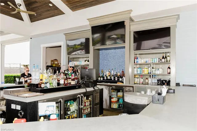 a dining hall with stainless steel appliances a dining table and chairs with wooden floor