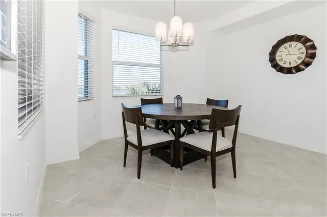 a dining room with furniture a chandelier and a rug