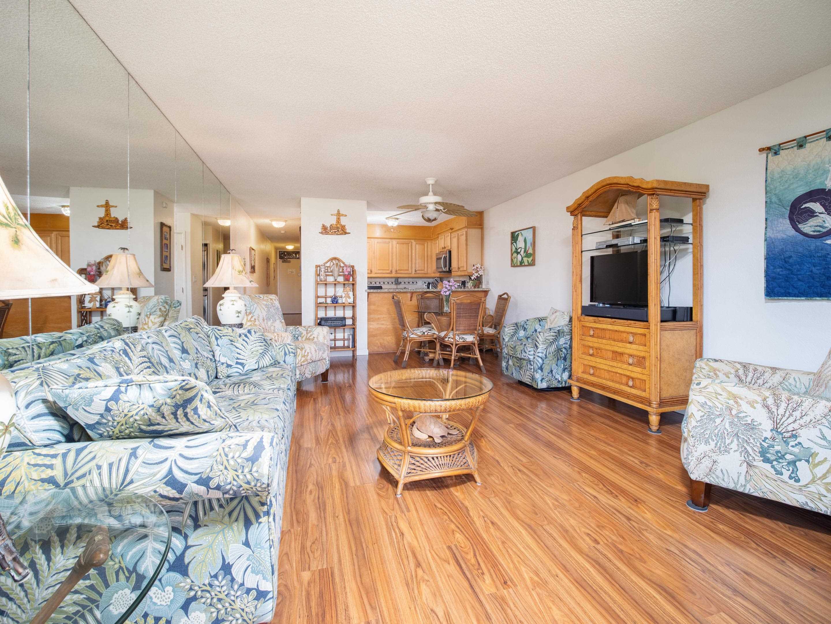 2695 South Kihei Road, Unit 7204 Kihei, HI 96753 - Photo 2 of 32 a living room with furniture and a wooden floor
