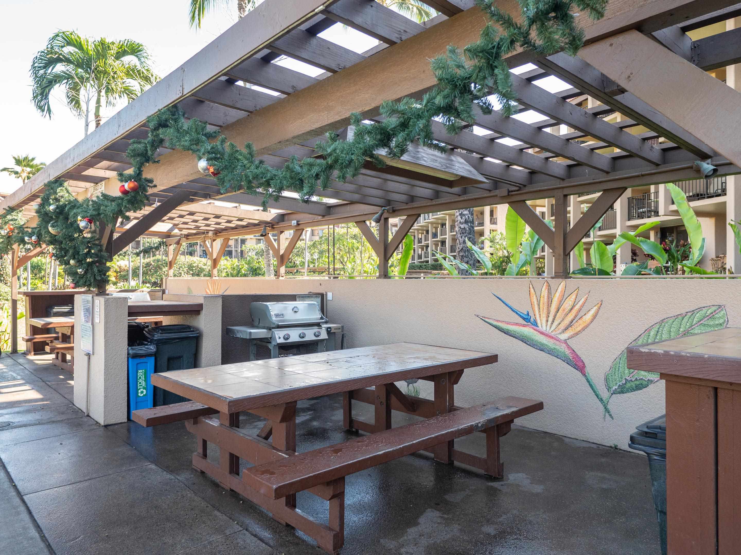 2695 South Kihei Road, Unit 7204 Kihei, HI 96753 - Photo 25 of 32 a view of a patio with table and chairs with a barbeque grill and plants