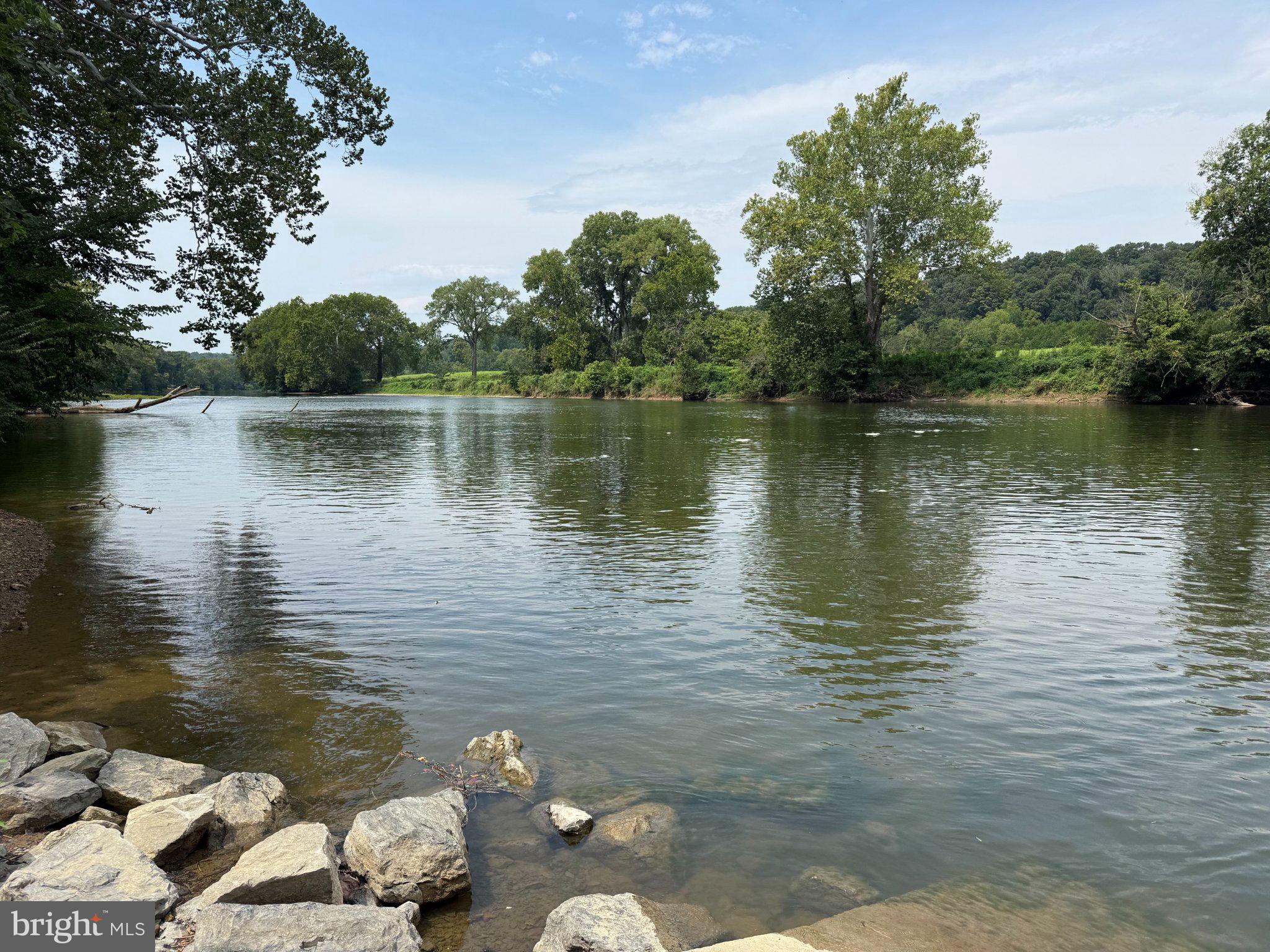 576 Manor Road Front Royal, VA 22630 - Photo 39 of 41 Serene riverbank under a clear sky.