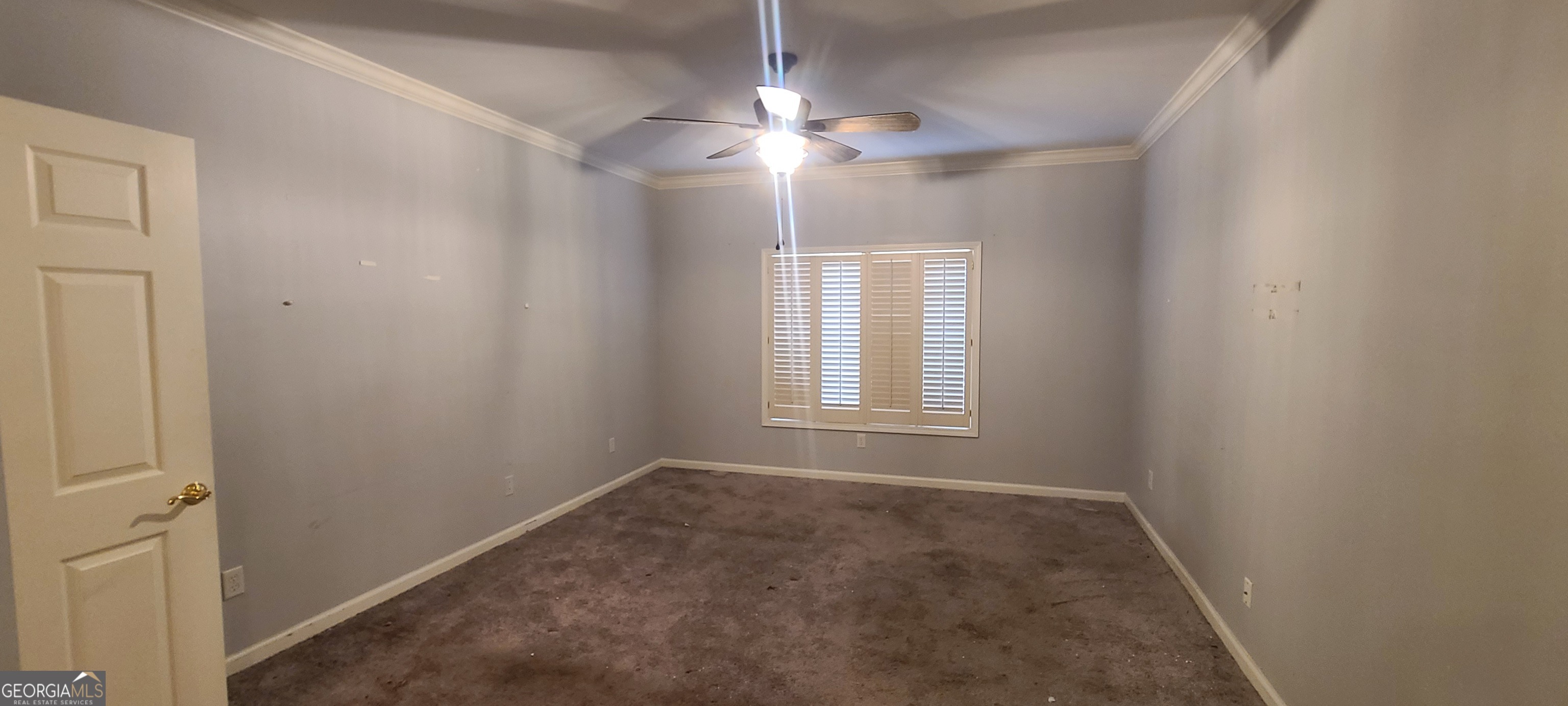 3047 Lenox Road Northeast, Unit 2107 Atlanta, GA 30324 - Photo 12 of 27 an empty room with windows and fan