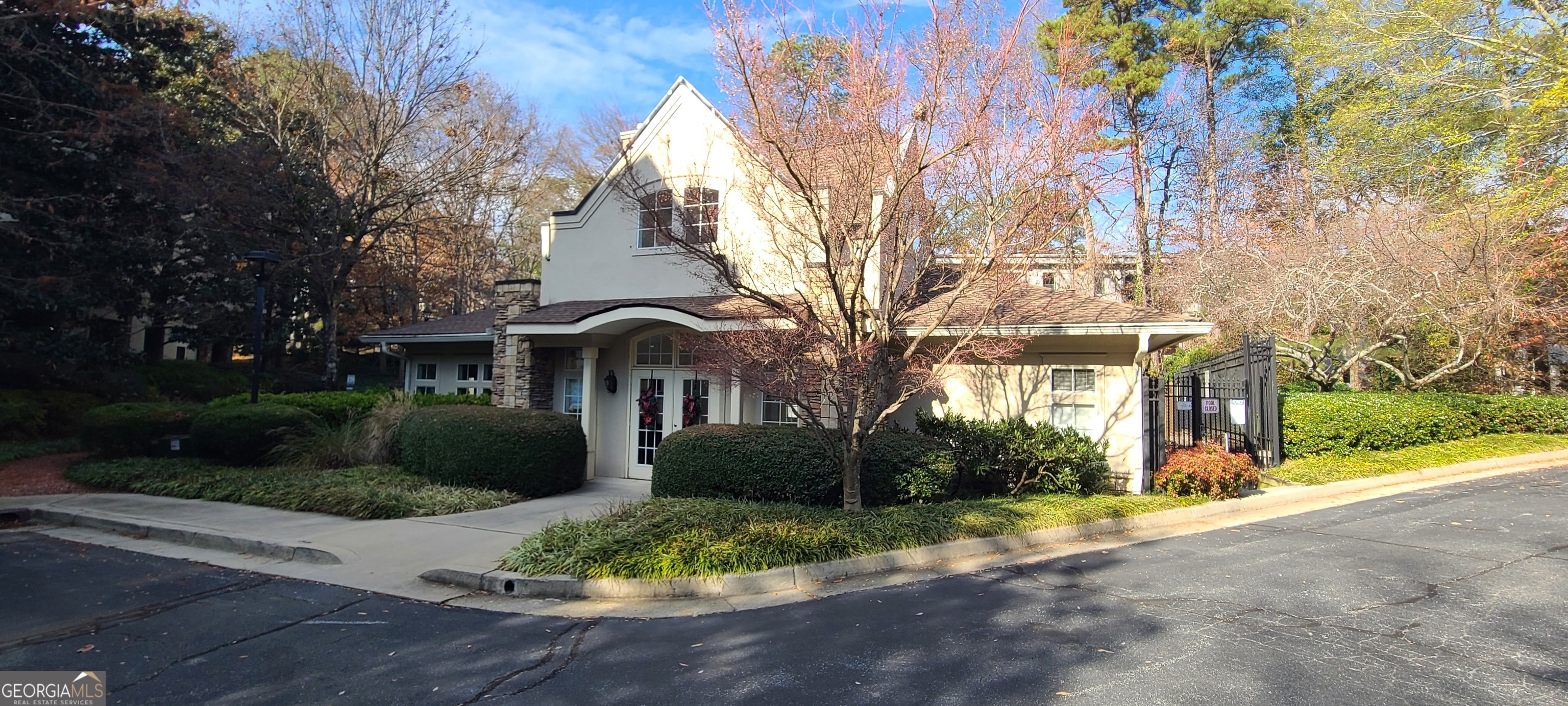 3047 Lenox Road Northeast, Unit 2107 Atlanta, GA 30324 - Photo 23 of 27 a front view of a house with a yard and garage