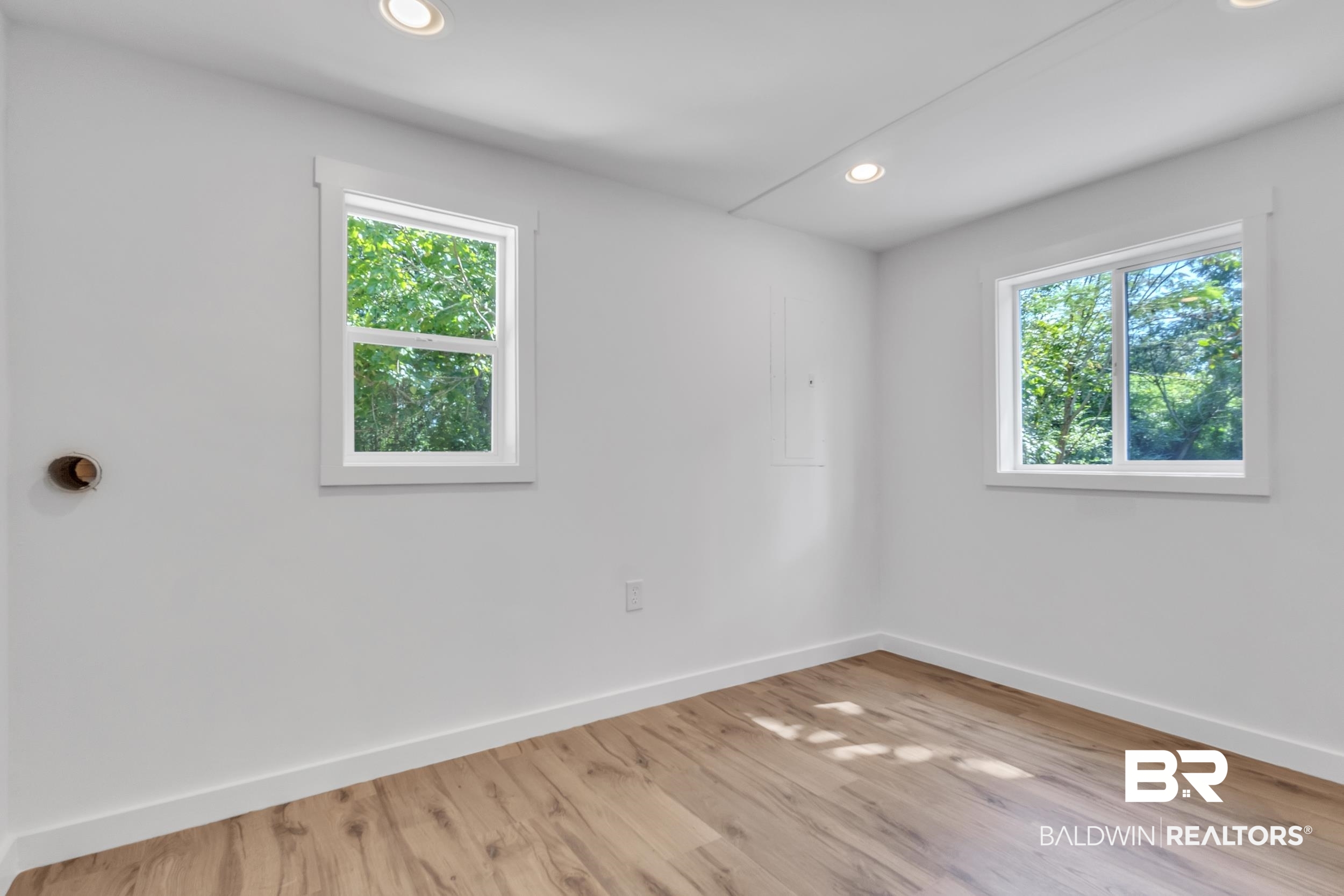 14001 Melvin Johnson Road Stapleton, AL 36578 - Photo 22 of 31 Empty room with plenty of natural light, recessed lighting, and light wood finished floors