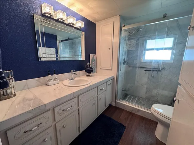 a bathroom with a double vanity sink mirror and toilet