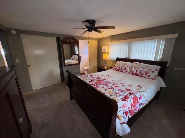 a bedroom with a bed and a mirror