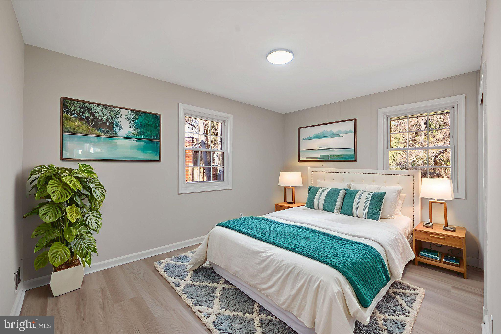 1513 Flora Lane Silver Spring, MD 20910 - Photo 22 of 49 a bedroom with a bed and a painting on the wall