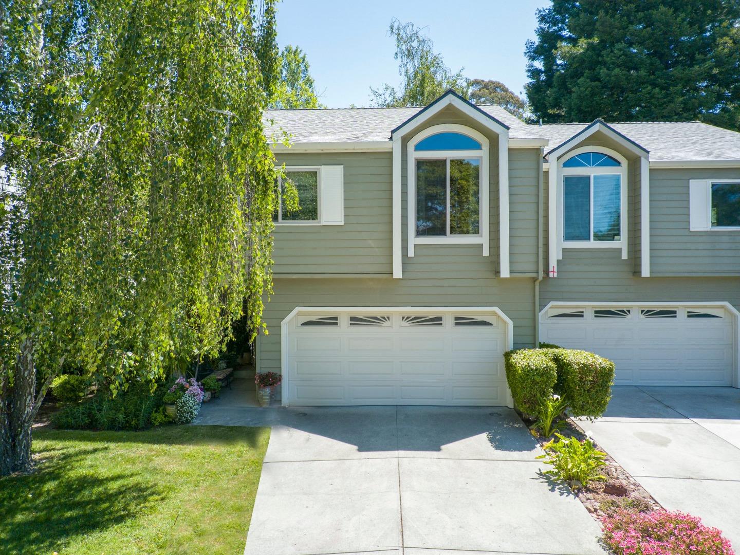 a front view of a house with a garden and outdoor seating