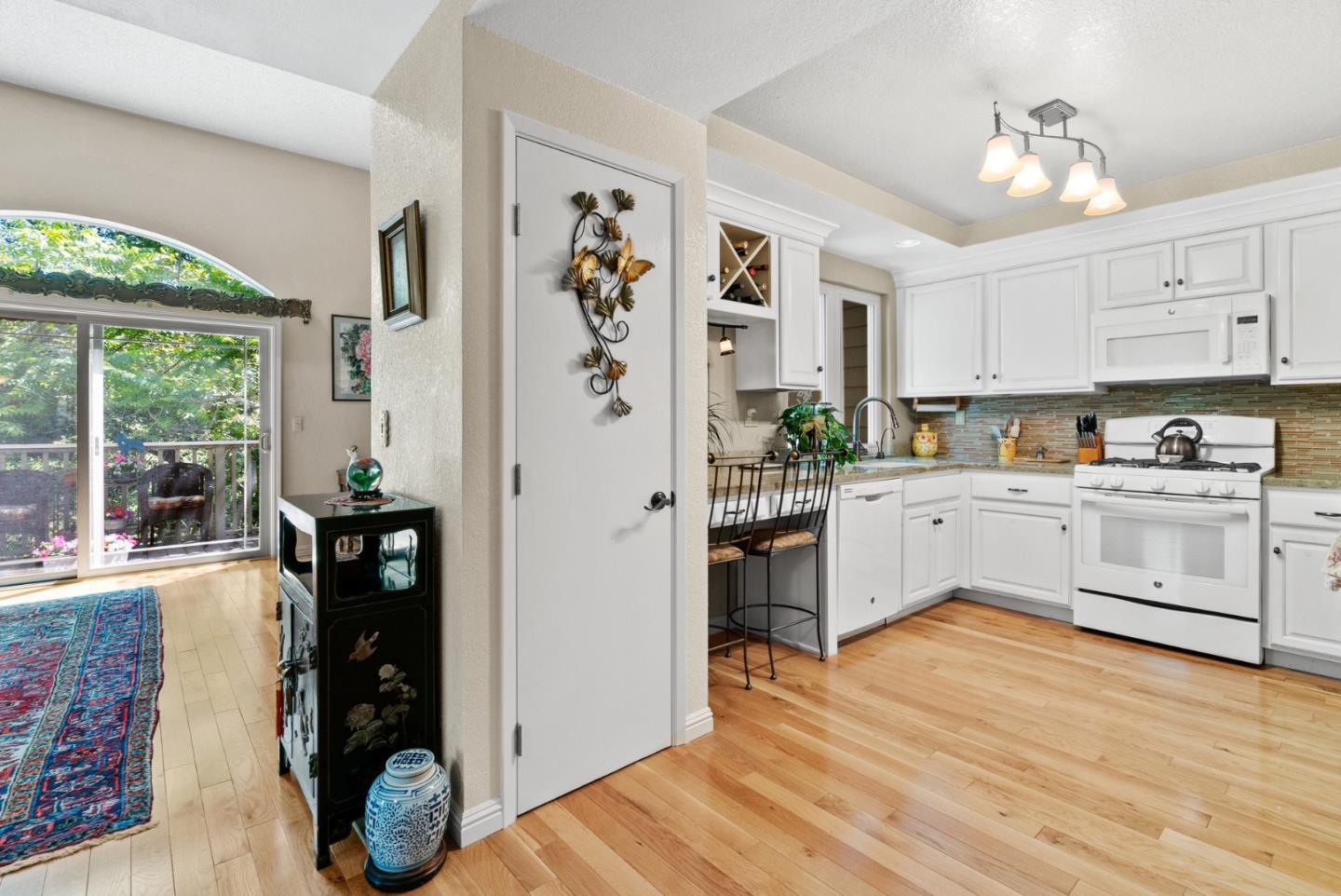 103 Stoney Creek Road Santa Cruz, CA 95060 - Photo 19 of 44 a kitchen with stainless steel appliances white cabinets and wooden floor