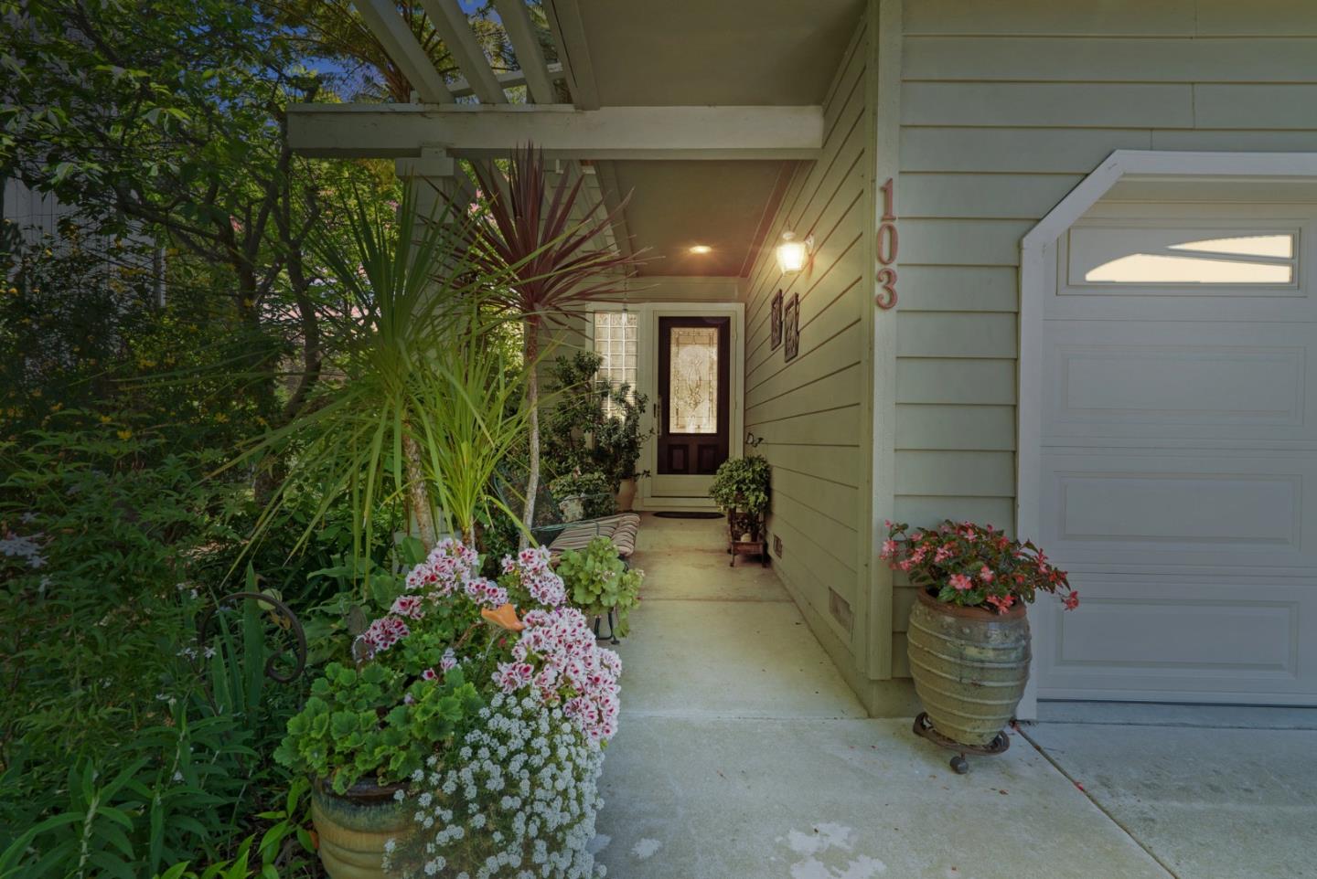 103 Stoney Creek Road Santa Cruz, CA 95060 - Photo 3 of 44 a view of a porch with chairs and potted plants