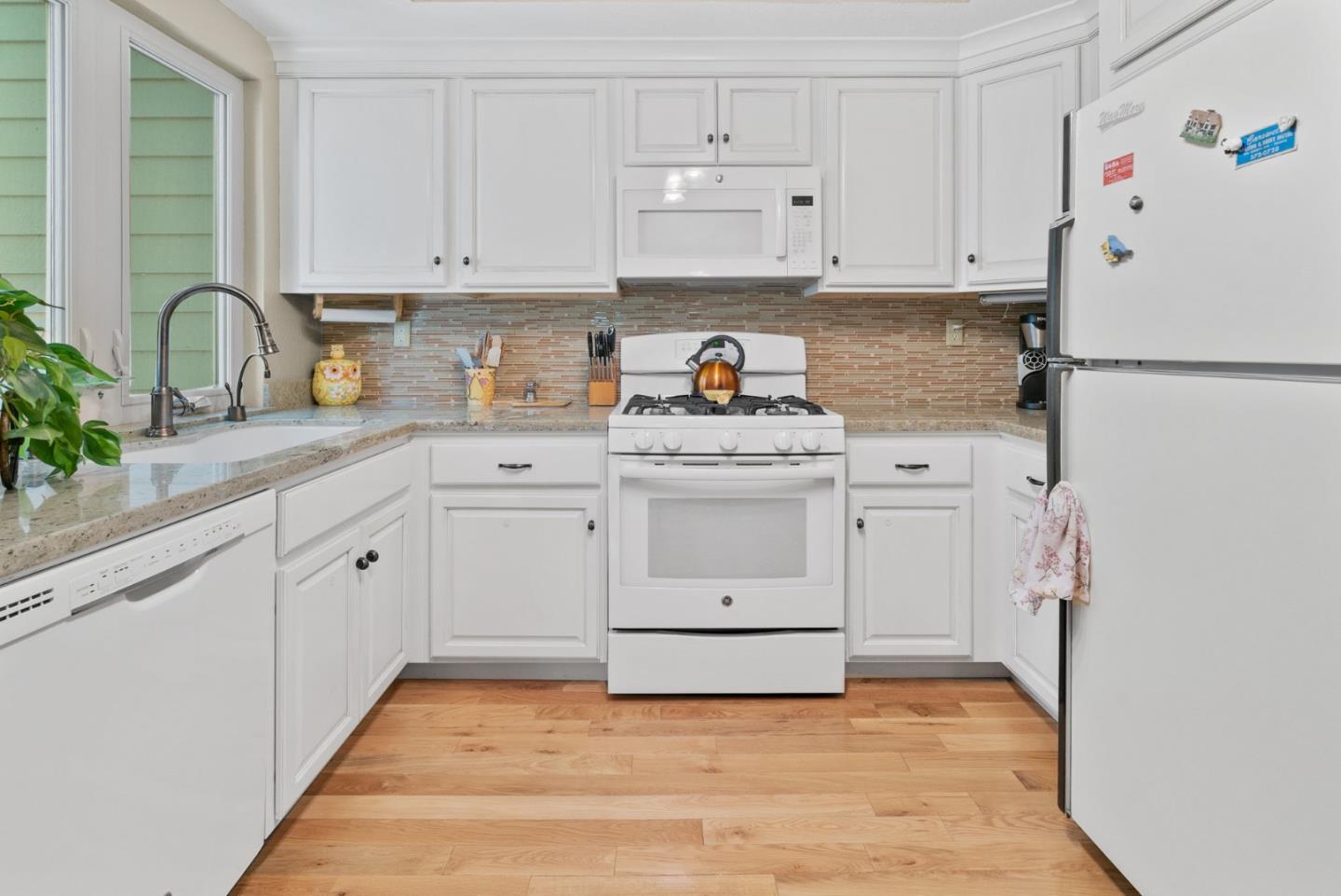 103 Stoney Creek Road Santa Cruz, CA 95060 - Photo 21 of 44 a kitchen with white cabinets and white appliances
