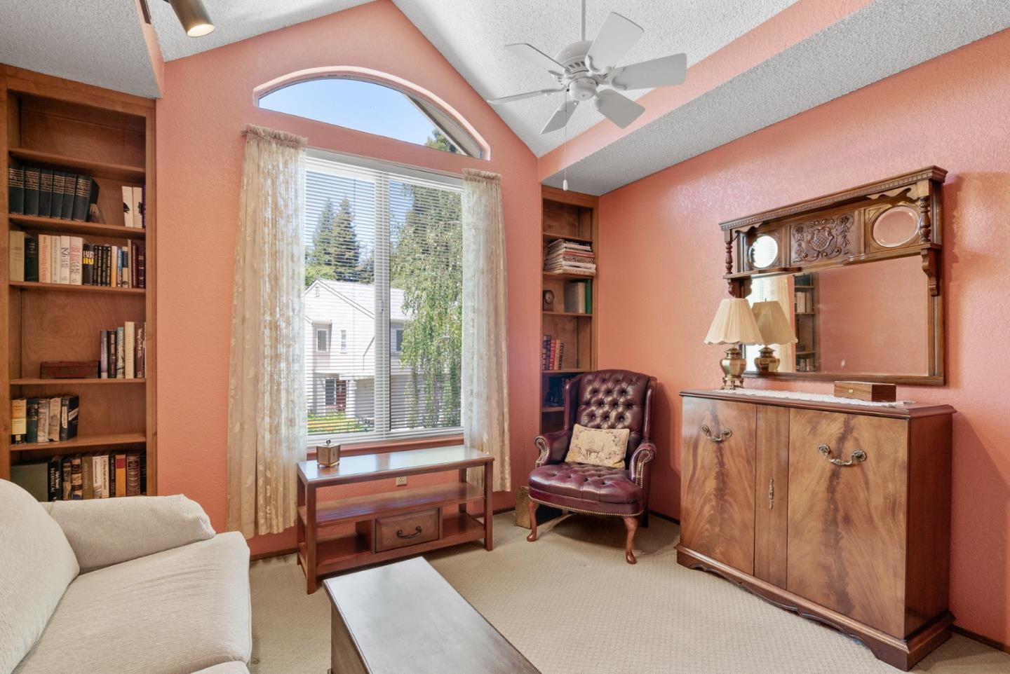 103 Stoney Creek Road Santa Cruz, CA 95060 - Photo 35 of 44 a living room with furniture a bookshelf and a window