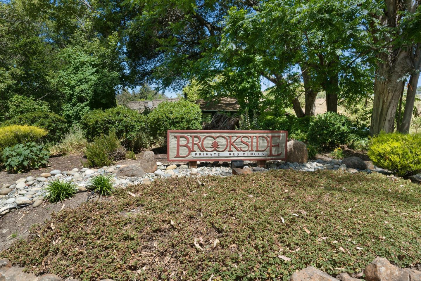 103 Stoney Creek Road Santa Cruz, CA 95060 - Photo 41 of 44 a sign of golf club on a stone wall under a large tree