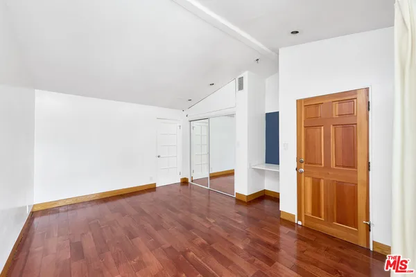 an empty room with wooden floor