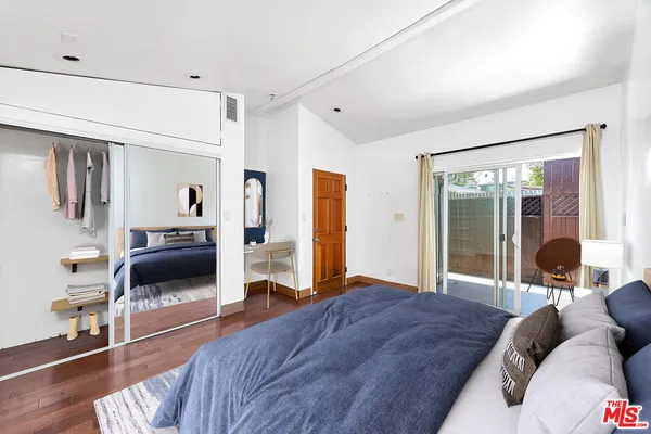 a bedroom with a bed and a large window