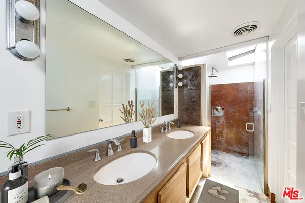 a bathroom with a granite countertop sink and a mirror