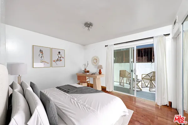 a bedroom that has a bed and a chair in it