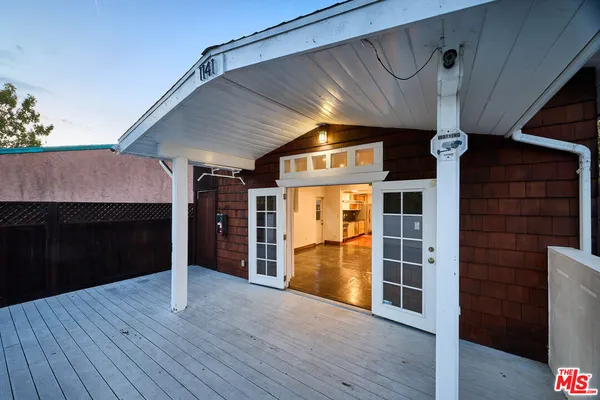 a view of a house with door and wooden floor