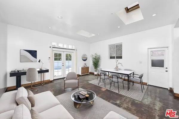 a living room with furniture a rug and a table
