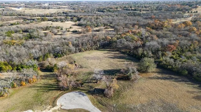 an aerial view of a houses with yard