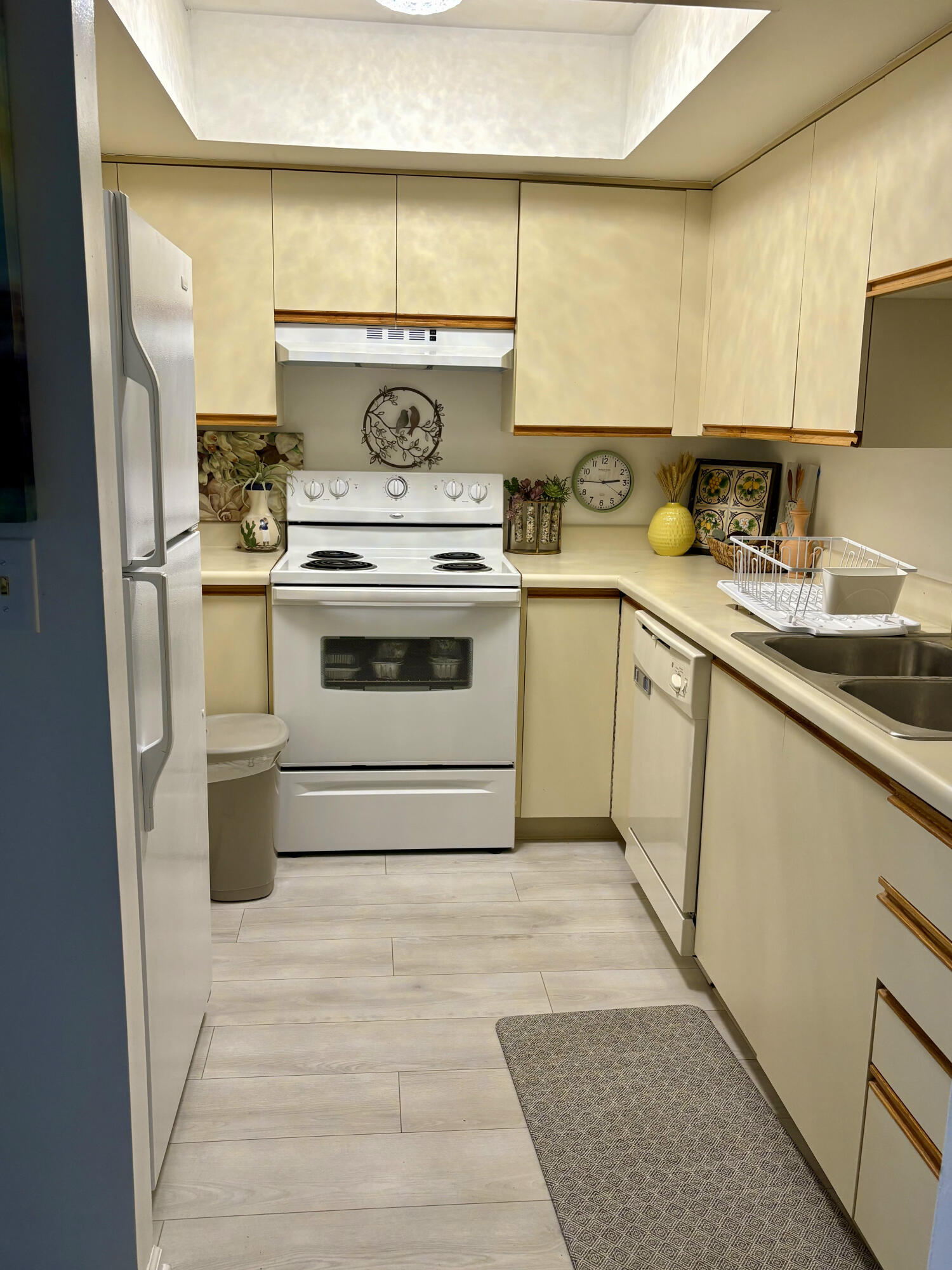 540 Southwest South River Drive, Unit 204 Stuart, FL 34997 - Photo 7 of 15 a kitchen with a stove top oven sink and cabinets