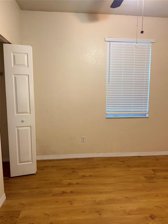 9073 Plymouth Place Tamarac, FL 33321 - Photo 13 of 16 a view of an empty room with wooden floor and a window