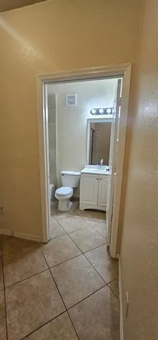 a view of an empty room with a fan