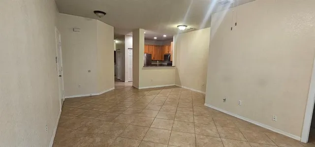 an empty room with a ceiling fan and a window