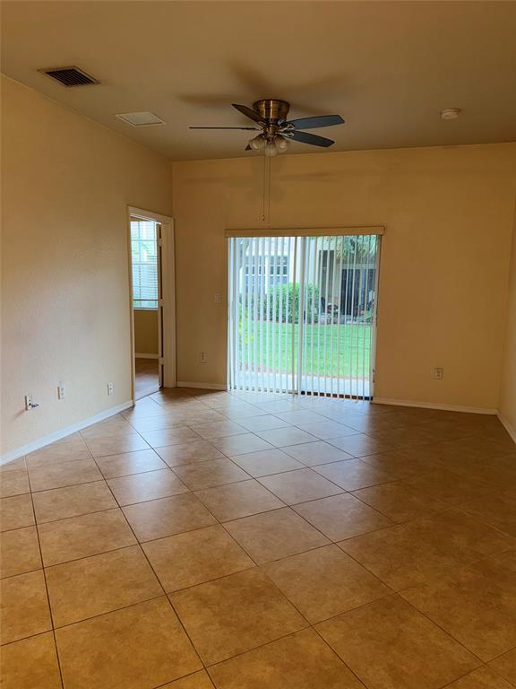 9073 Plymouth Place Tamarac, FL 33321 - Photo 9 of 16 a view of a room with furniture and a window